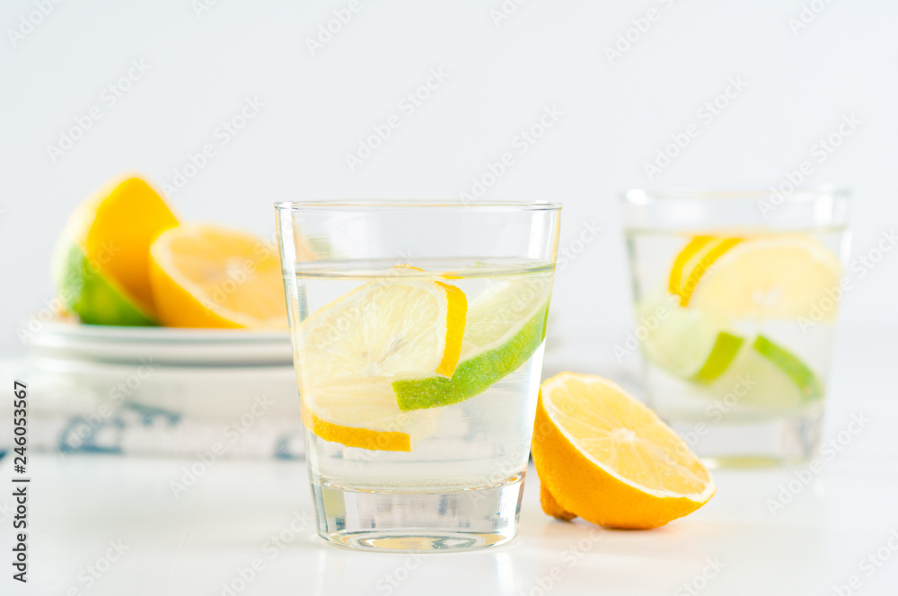 glass of water with lemon and lime glass of water with lemon and lime
