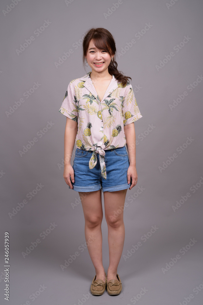 Full length portrait of beautiful young Asian woman standing Full length portrait of beautiful young Asian woman standing