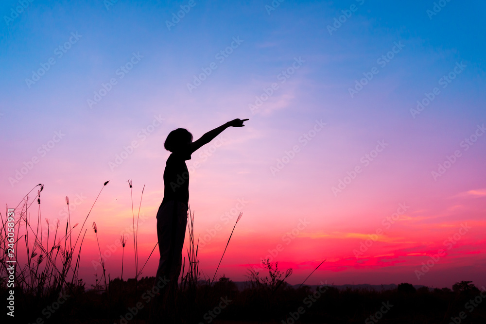 silhouette  woman on field over sunset