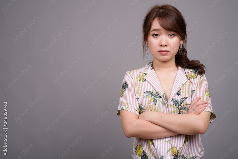 Portrait of young beautiful Asian tourist woman in studio Portrait of young beautiful Asian tourist woman in studio