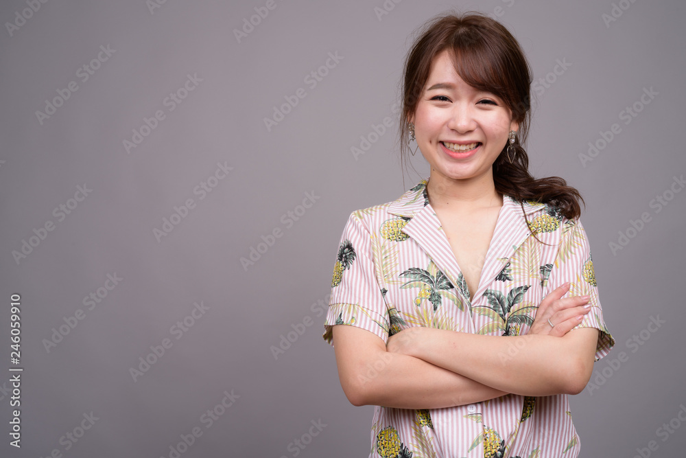 Portrait of young beautiful Asian tourist woman in studio Portrait of young beautiful Asian tourist woman in studio