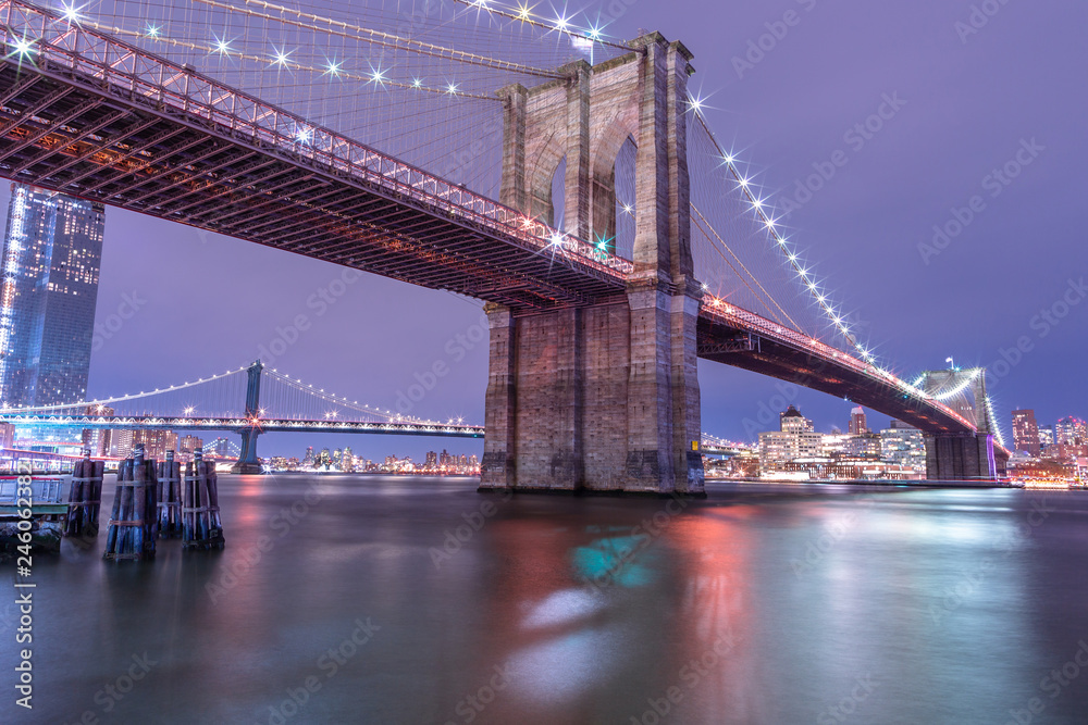 View on Brooklyn Bridge and Manhattan Bridge from East River at night  with long exposure