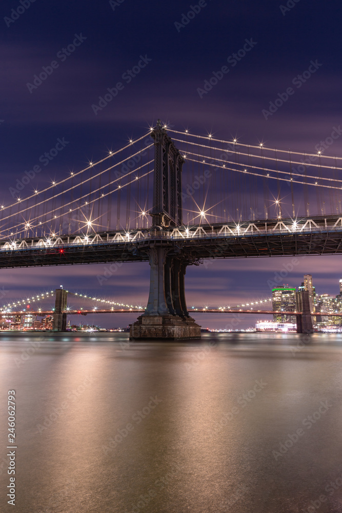 View on Manhattan bridge and Brooklyn bridge form east river at night with long exposure 