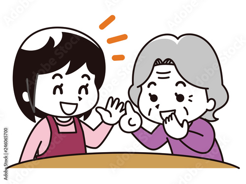 会話をする女性介護士と高齢女性