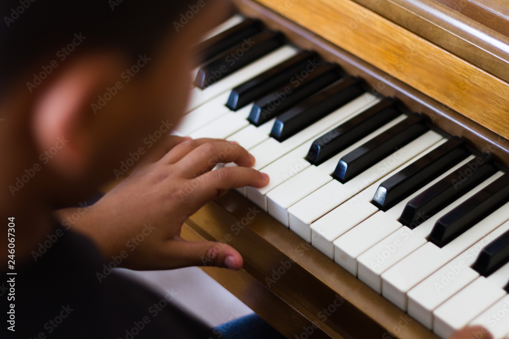 Fototapeta premium Young child playing the piano