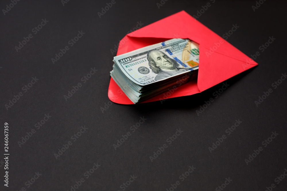 Dollar money in the red envelope on black background bonus, reward, benefits concept. Dollar money in the red envelope on black background bonus, reward, benefits concept.