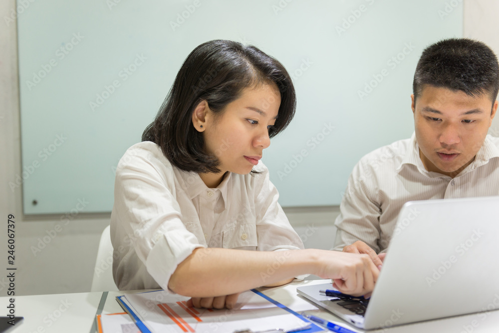 Two business people discuss about work in the office Two business people discuss about work in the office