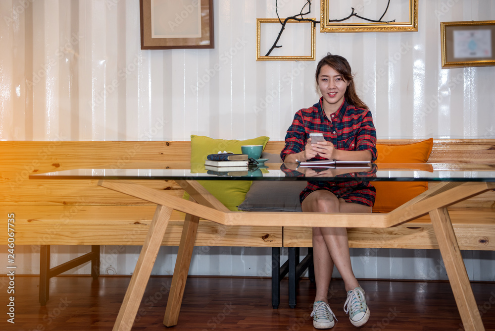 Hipster women with a coffee cup working in a coffee shop
