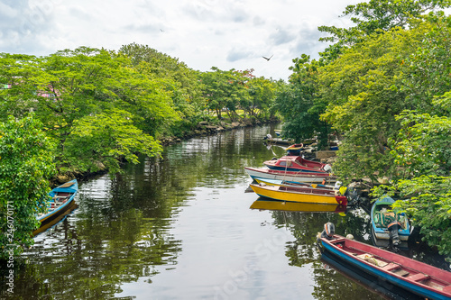 Colorful old fishing boats docked along the river in Negril, Jamaica. Caribbean countryside landscape.