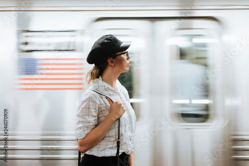 Thoughtful woman waiting for a train at a subway platform