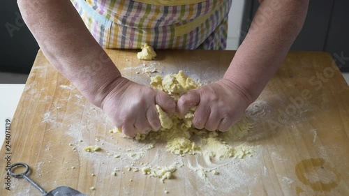 hands of woman making pasta gnocchi and orecchiette from dough process. typical italian food
