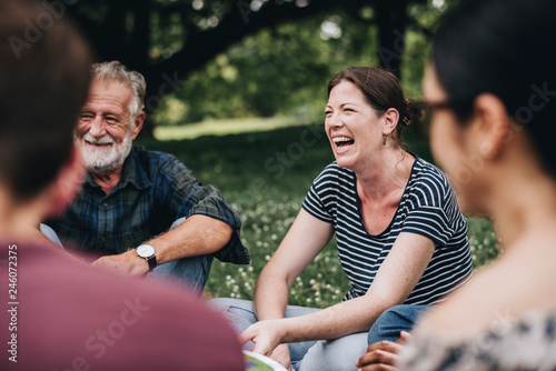 Cheerful woman in the park with her friends photo