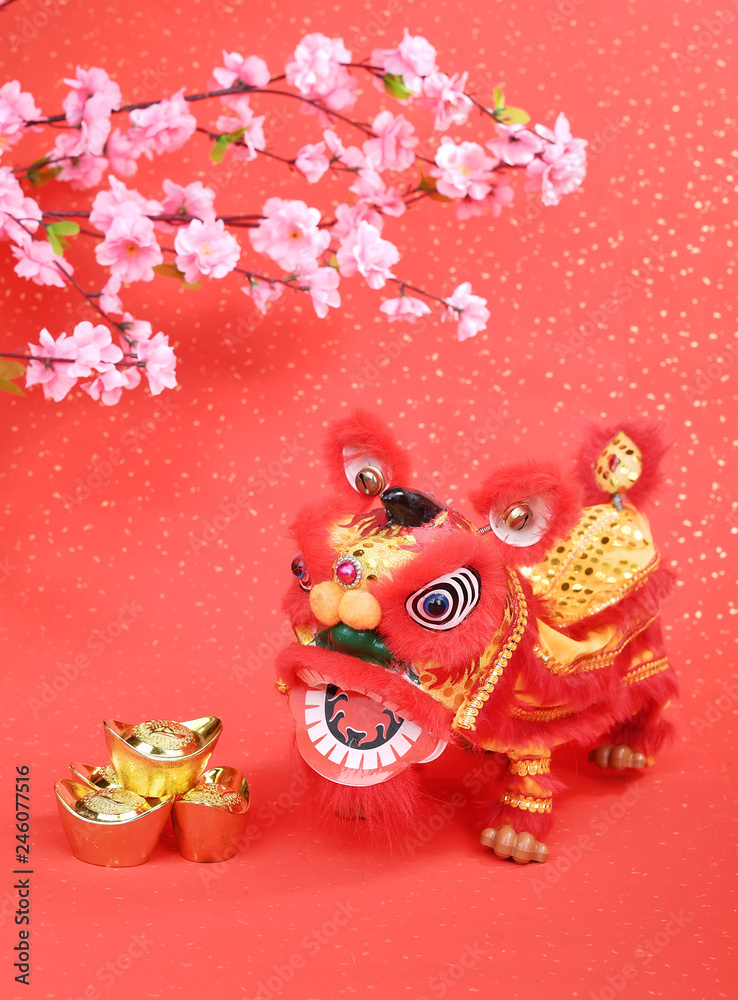 Fototapeta premium chinese traditional dancing lion with Gold ingot,Chinese calligraphy Translation:good bless for money