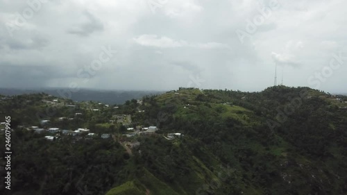 AERIAL: extreme wide pull away and tilt down between the mountain tops of Utuado, Puerto Rico. photo