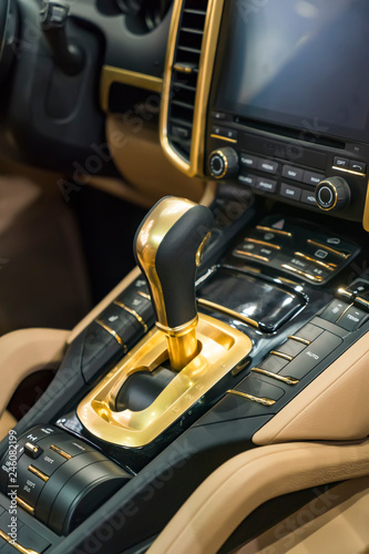 Modern Luxury car inside.golden automatic gear stick shift.