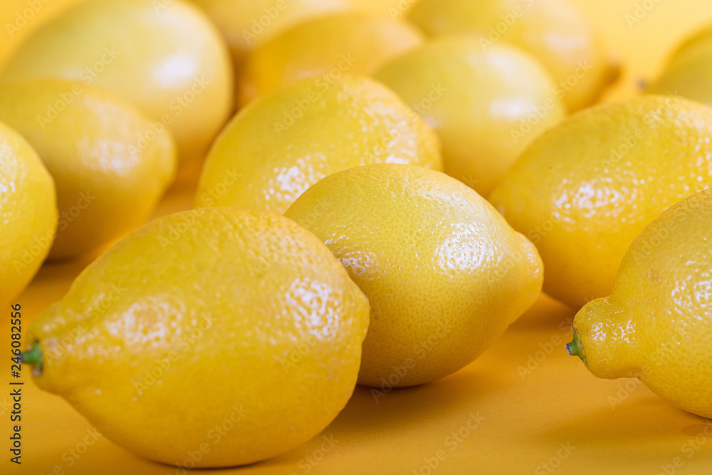 Fresh colorful yellow lemons on yellow background Fresh colorful yellow lemons on yellow background