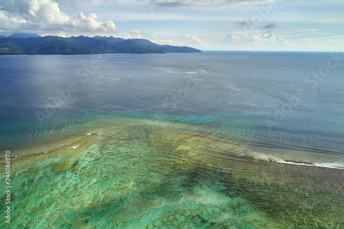 Tropical marine landscape of shallow sea on coastline background