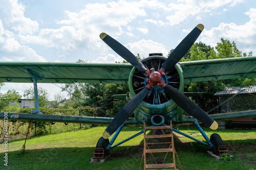 View on propeller on old russian airplane on green grass