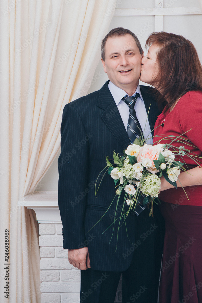couple in love kissing. Man and woman with flowers smiling. Valentine's day couple in love kissing. Man and woman with flowers smiling. Valentine's day