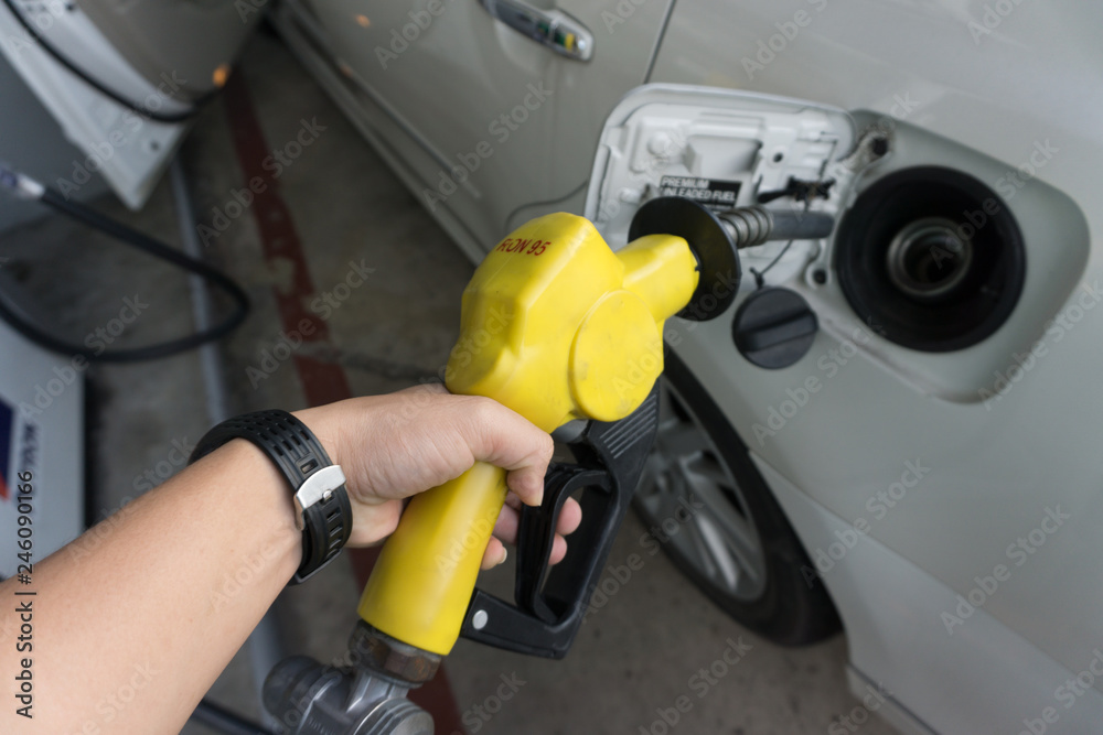 man hand Refueling gasoline fuel in car at gas station