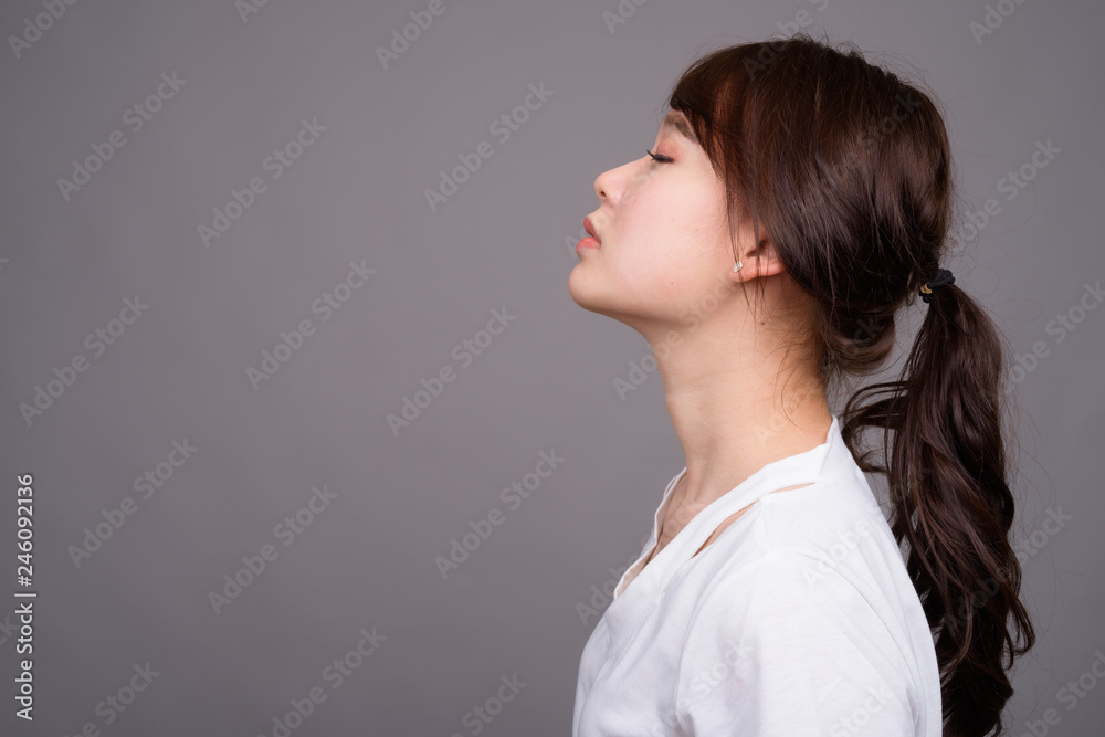 Profile view of young beautiful Asian woman with eyes closed Profile view of young beautiful Asian woman with eyes closed
