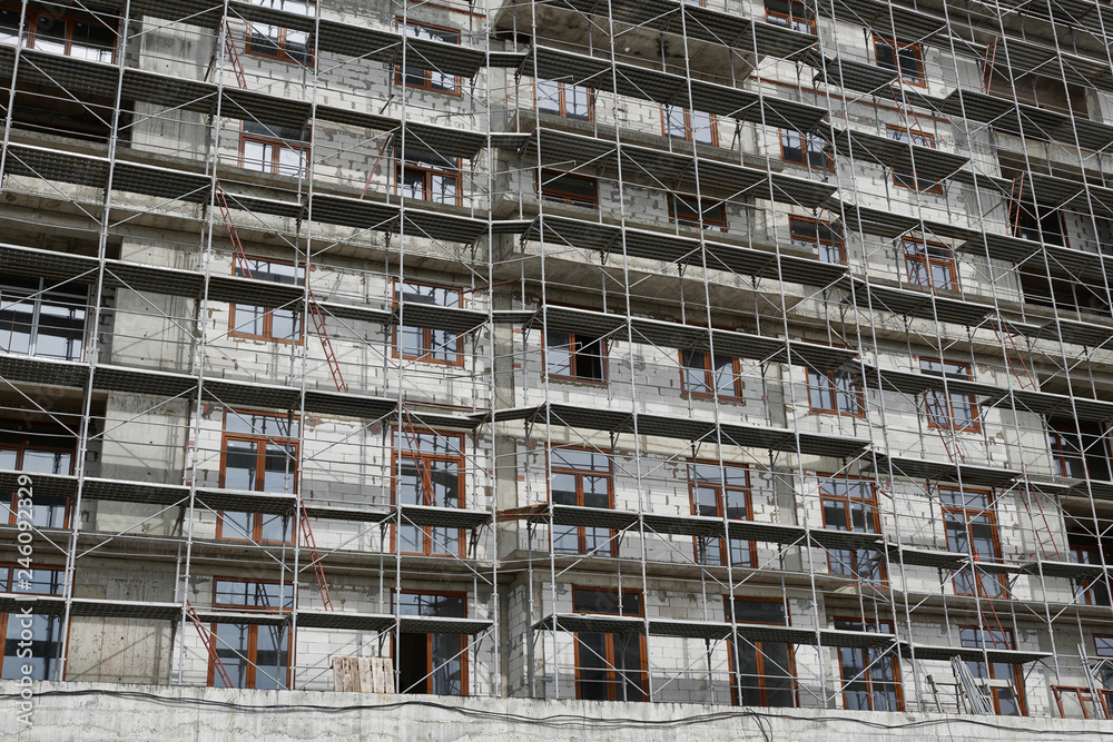 new building under construction, scaffolding and concrete new building under construction, scaffolding and concrete