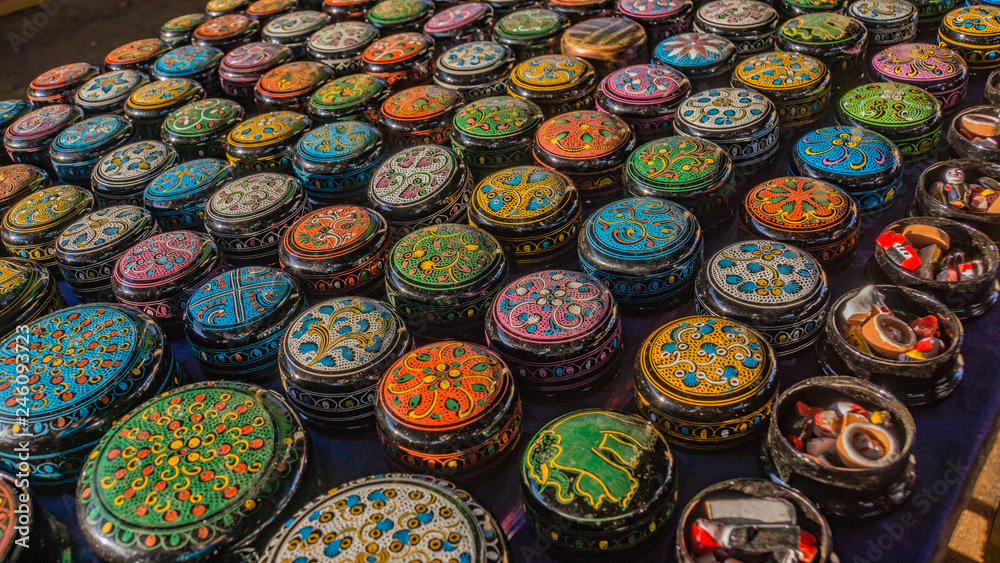 colorful designs and patterns of lacquer ware containers laid for sale at the floating market in Lake Inle, Myanmar
