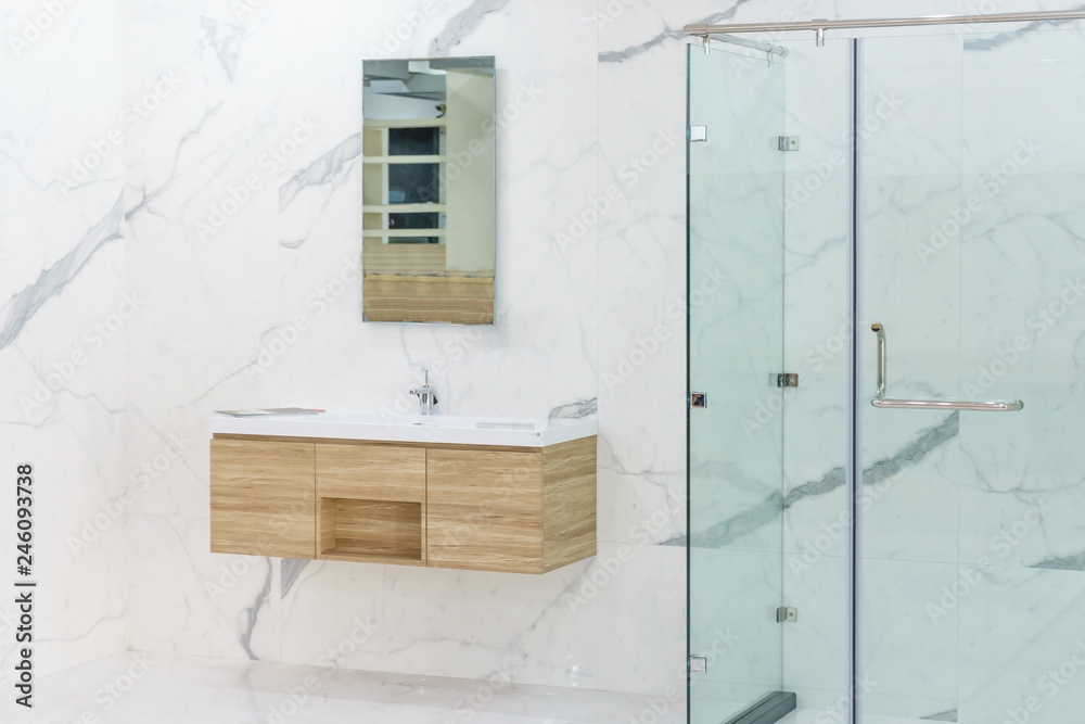 Spacious and bright modern bathroom interior with white walls, a shower ...