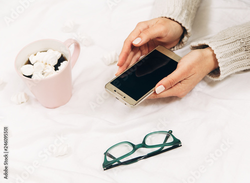 women's hands with phone,coffee,glasses.Minimal style
