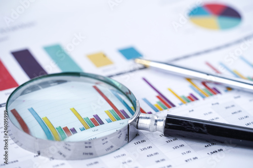 Magnifying glass on charts graphs spreadsheet paper. Financial development, Banking Account, Statistics, Investment Analytic research data economy, Stock exchange trading, Business office company meet