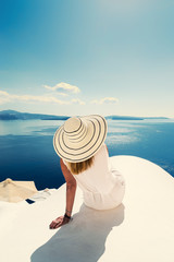 Luxury travel vacation woman looking at view on Santorini island