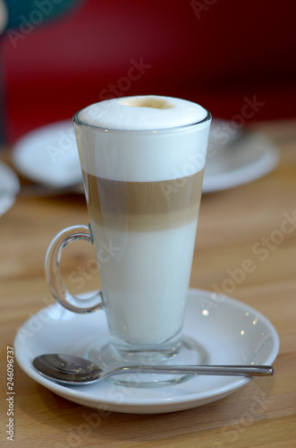 latte coffee in a transparent glass on a light background