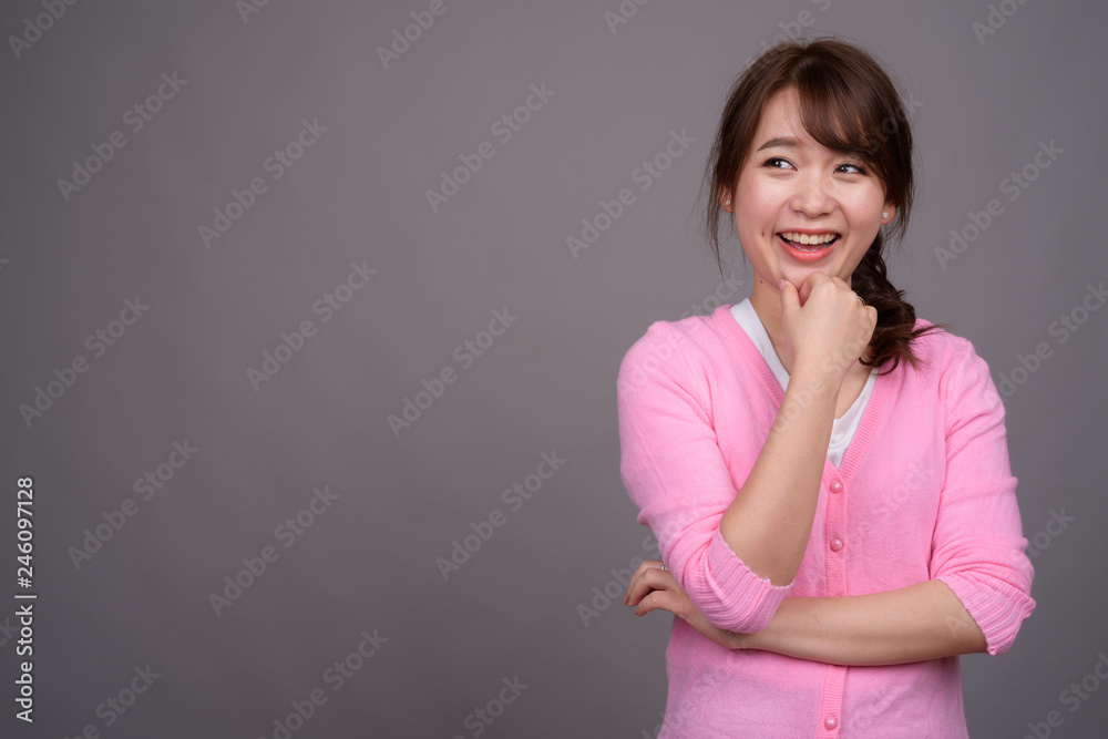 Young beautiful Asian woman wearing pink shirt Young beautiful Asian woman wearing pink shirt