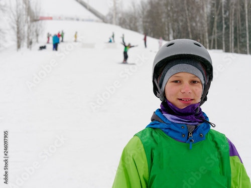 athlete a skier in a helmet cheerful portrait on the ski slope. photo
