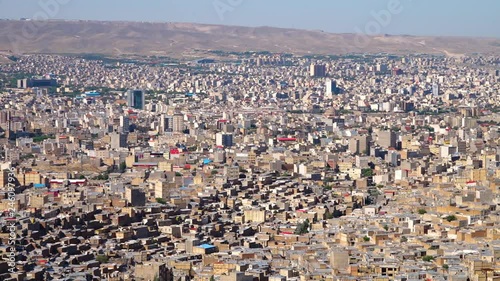Pan of sprawling city of Tabriz, Azerbaijan with the mountains in the background