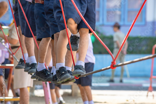 Children walking on the wire rope are doing the activity.
