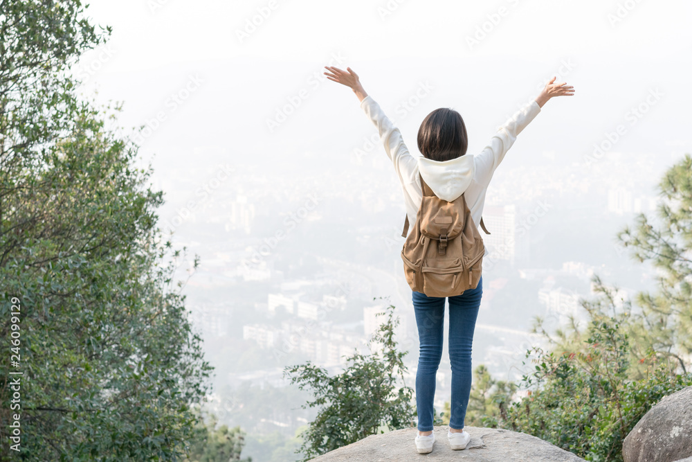 girl with backpack on peak of foggy mountain. girl with backpack on peak of foggy mountain.