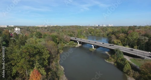 Cars Driving Over Bridge Aerial And Power Lines Near By photo