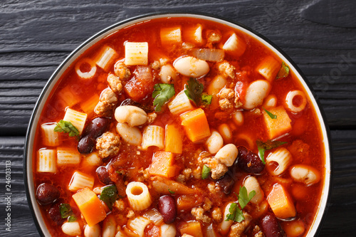 Thick Italian Pasta fagioli soup close-up in a bowl. horizontal top view photo