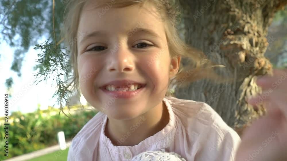 Portrait of a little toothless girl in the Park Portrait of a little toothless girl in the Park
