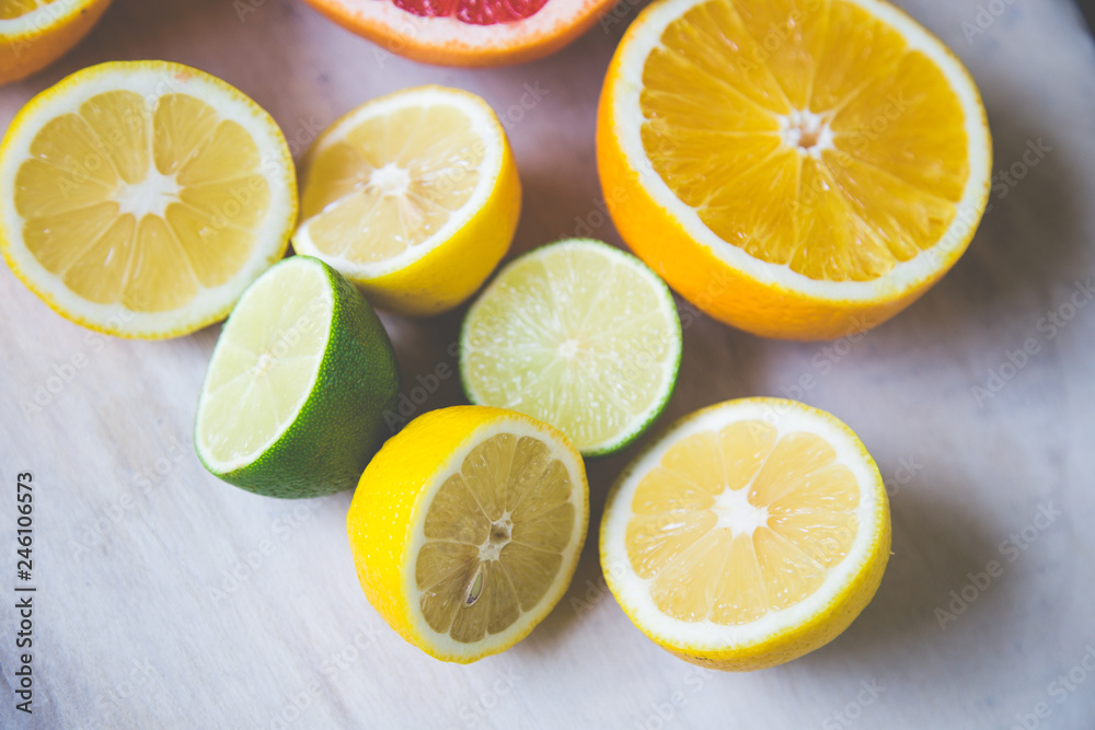 citrus fruits (grapefruit, orange, lemon, lime), on the wooden background.