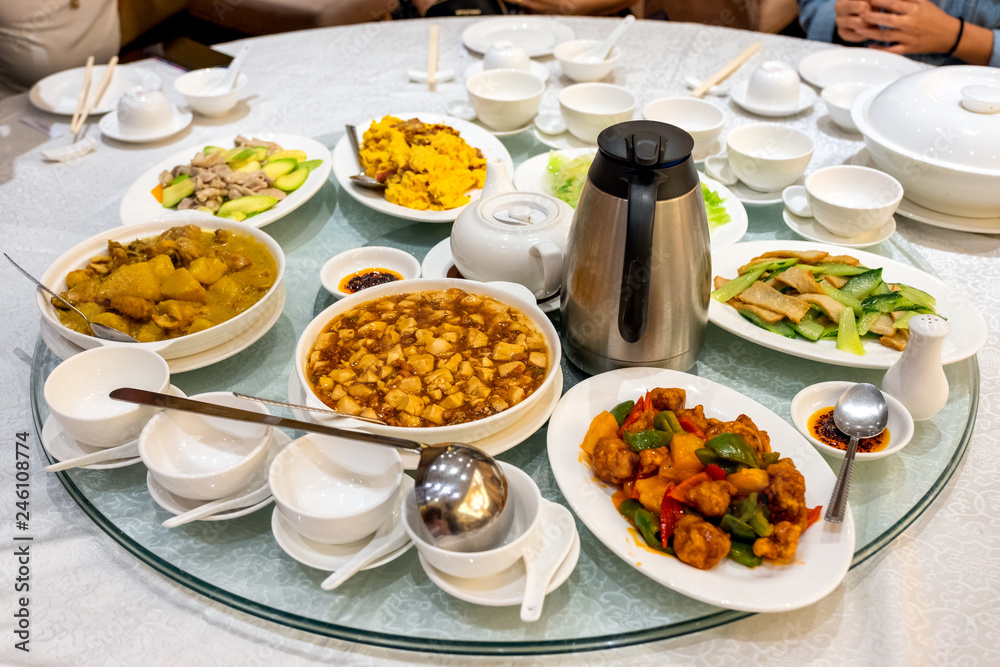 Variety asian food serving with tea preparing on glass round table