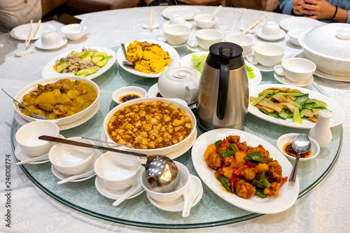 Variety asian food serving with tea preparing on glass round table