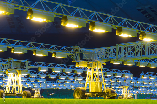 Mobile grow lighting system in sports stadium at night. photo