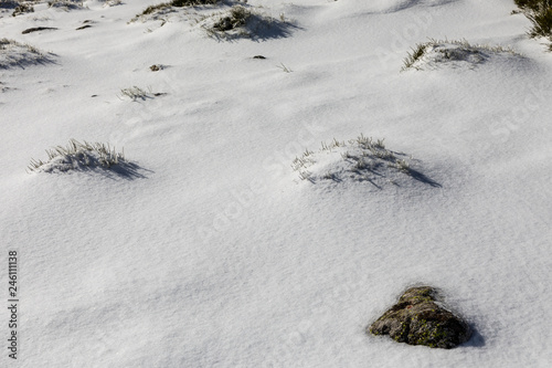 rocks covered with ice, water and snow in the mountains of Madrid photo