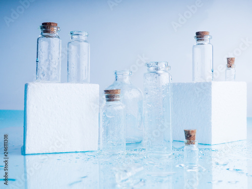 Few transparent bottles, water sprays. empty glass bottles. photo