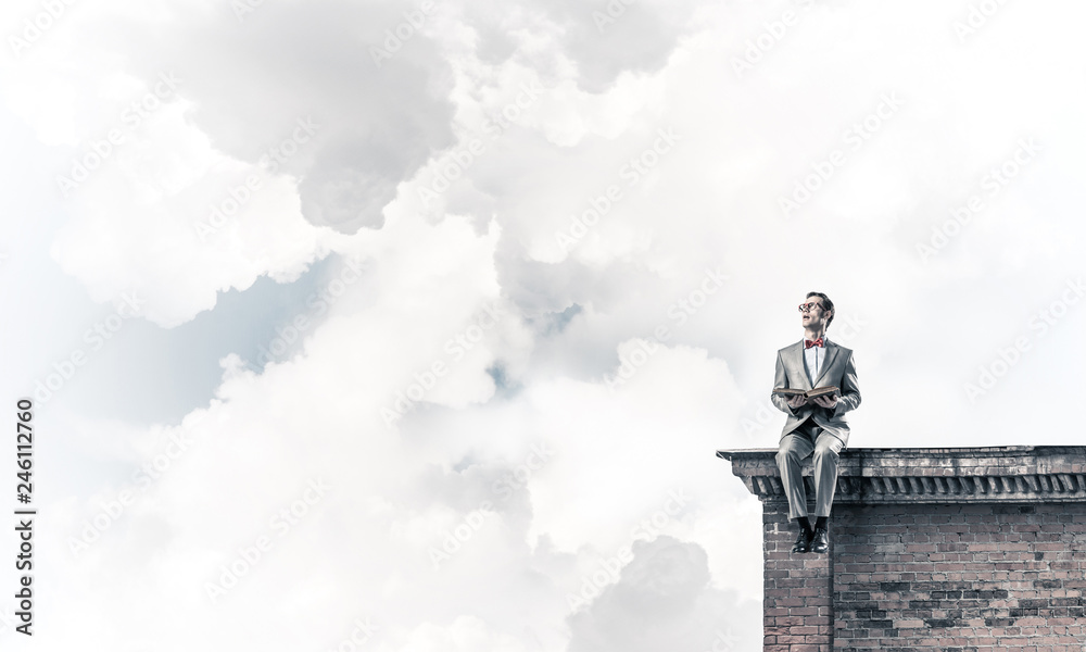 Young businessman or student studying the science on building roof Young businessman or student studying the science on building roof