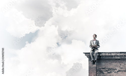 Young businessman or student studying the science on building roof
