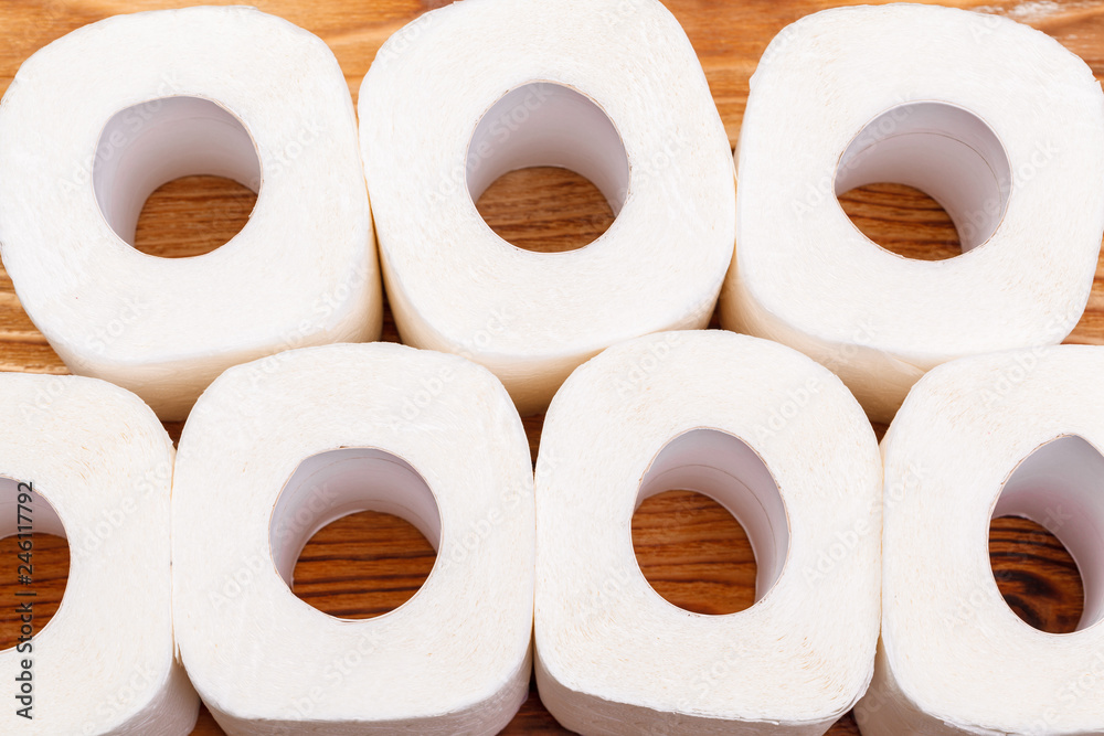 Toilet paper rolls on wooden background top view Toilet paper rolls on wooden background top view