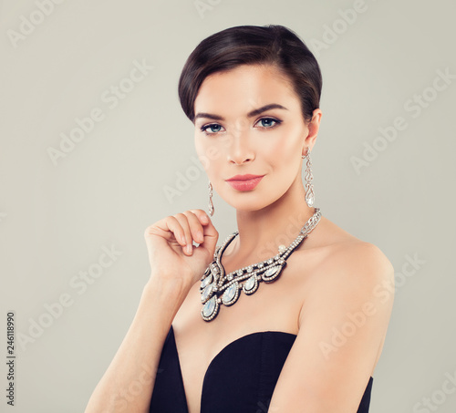 Glamorous woman with short haircut, makeup, diamond necklace and earrings portrait